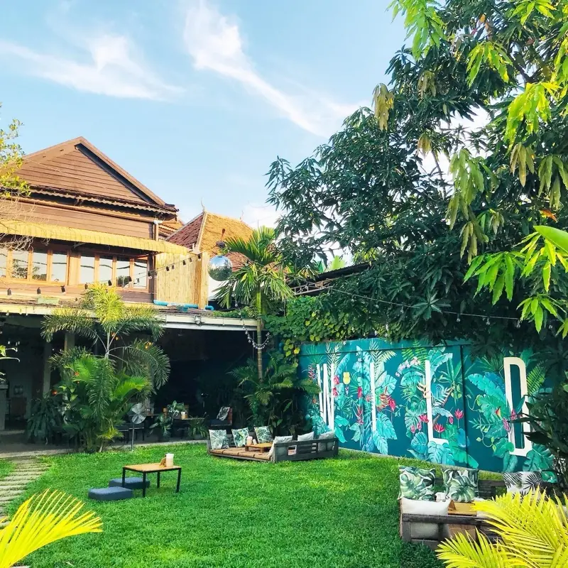 The wooden Khmer house of WILD Siem Reap and its garden